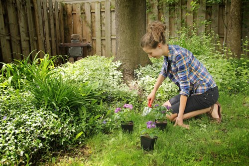 Workers sorting garden waste into containers at a sustainable rubbish gardening area
